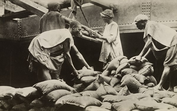 Loading sacks of tin ore at Iddo. Nigerian labourers load sacks of tin ore onto a freight car at Iddo railway station. The tin was imported from the Bauchi Plateau and was bound for Lagos. Iddo Island, near Lagos, Nigeria, circa 1935., Lagos, Nigeria, Western Africa, Africa.