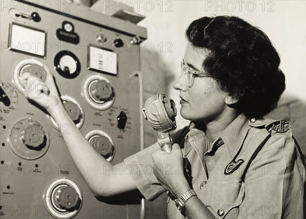 Kenya Police Airwing radio operator. Rosalind Balcon operates a radio in the communications room of the Kenya Police Airwing. Kenya, circa 1955. Kenya, Eastern Africa, Africa.