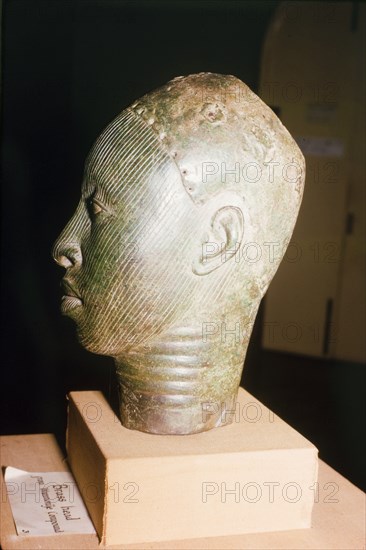 Yoruba bronze sculpture. A bronze sculpture of a head, possibly a royal or religious effigy, from the ancient Yoruba city of Ife. The Yoruba custom of sculpting figures flourished during the 14th and 15th centuries, when they began making life-like bronze sculptures. Ife, Nigeria, 1963. Ife, Osun, Nigeria, Western Africa, Africa.