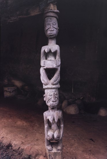 A Yoruba wood carving. A Yoruba wood carving of two women kneeling one on top of the other. In Yoruba art, women are often depicted kneeling or holding bowls as a symbol of gift-giving or nurturing. Oyo, Western Region (Oyo State), Nigeria, 1963. Oyo, Oyo, Nigeria, Western Africa, Africa.