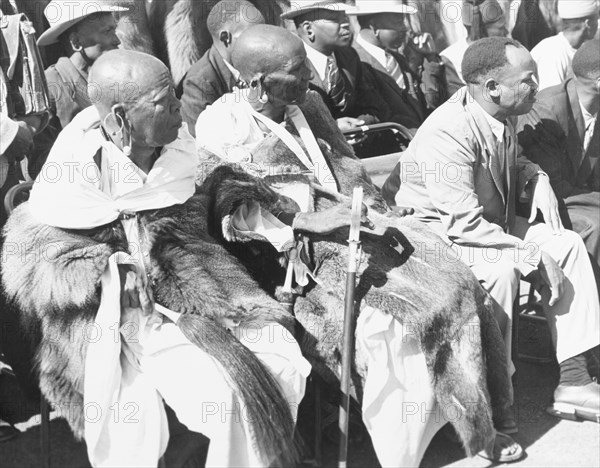 Awaiting the arrival of Princess Elizabeth. African chiefs in ceremonial dress sit on a spectator stand as they await the arrival of Princess Elizabeth at Eastleigh Airport. Nairobi, Kenya, February 1952. Nairobi, Nairobi Area, Kenya, Eastern Africa, Africa.