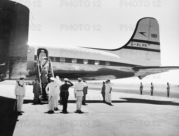 Princess Elizabeth arrives at Eastleigh Airport. Princess Elizabeth and the Duke of Edinburgh are saluted by Sir Phillip Mitchell, the Governor of Kenya, and other government officials as they disembark from an aeroplane at Eastleigh Airport. Nairobi, Kenya, February 1952. Nairobi, Nairobi Area, Kenya, Eastern Africa, Africa.