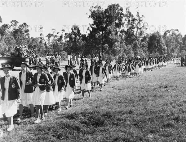 Convent schoolgirls arrive at Government House. A long line of convent schoolgirls arrive at Government House to greet Princess Elizabeth and the Duke of Edinburgh during their royal tour of Kenya. Nairobi, Kenya, February 1952. Nairobi, Nairobi Area, Kenya, Eastern Africa, Africa.