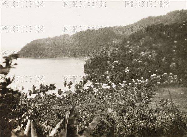 Charlotteville and Man-O-War Bay. View of the village of Charlotteville nestled in the foothills of the mountains by Man-O-War Bay. Tobago, circa 1931., Trinidad and Tobago, Trinidad and Tobago, Caribbean, North America .