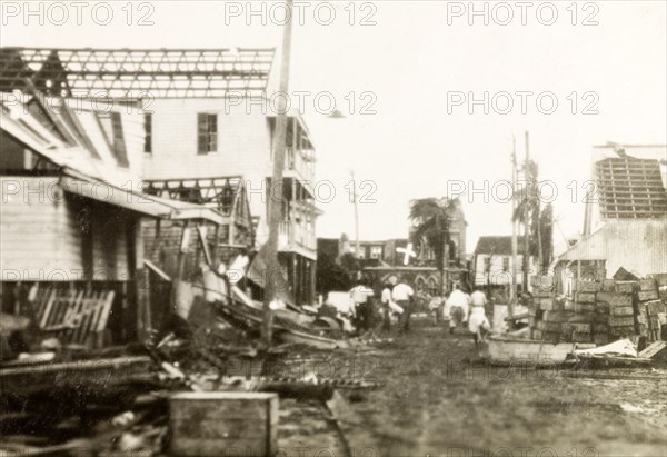 Clearing up debris after a hurricane, Belize. Relief workers begin to clear the rubble from a street devastated by a hurricane that hit Belize City on 10 September 1931, destroying two-thirds of the buildings and killing over 1000 people. Belize City, Belize, September 1931. Belize, Belize, Belize, Central America, North America .