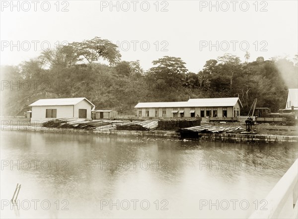 San Fernando railway station, Trinidad. View across a river to a steam locomotive pulled in at San Fernando railway station. San Fernando, Trinidad, circa 1912. San Fernando, Trinidad and Tobago, Trinidad and Tobago, Caribbean, North America .