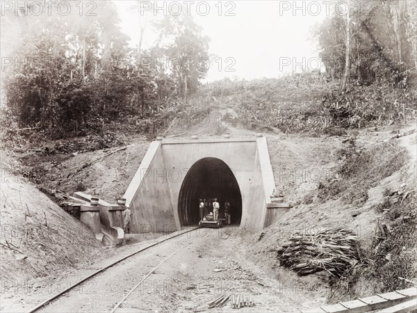 Tunnel on the Caparo Valley line, Trinidad. Trinidad Government Railway workers stand on a hand-operated rail cart at the north-facing entrance of a tunnel on the Caparo Valley extension line. Trinidad, circa 1912., Trinidad and Tobago, Trinidad and Tobago, Caribbean, North America .