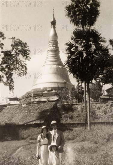 Tourists at the Shwe Dagon Pagoda. British tourists pose in front of the golden dome of the Shwe Dagon Pagoda. Rangoon, Burma (Yangon, Myanmar), 1931. Yangon, Yangon, Burma (Myanmar), South East Asia, Asia.