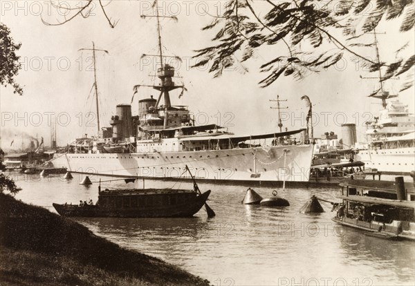 HMS Exeter in Calcutta docks. View of Royal Navy cruiser HMS Exeter moored in the docks at Calcutta. Calcutta (Kolkata), India, 1931. Kolkata, West Bengal, India, Southern Asia, Asia.