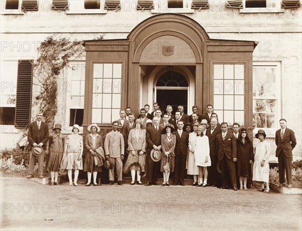 Dignitaries at Government House, St Helena. Group portrait of European and St Helenian dignitaries posing outside the porch of Government House. St Helena, circa 1926. St Helena, Atlantic Ocean, Africa.