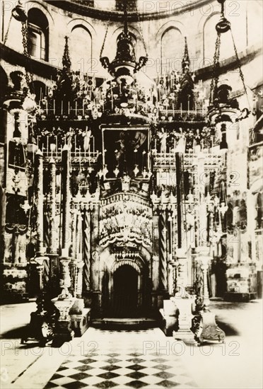 Tomb of Jesus, Jerusalem. View of the ornate aedicule marking the Tomb of Jesus inside the Church of the Holy Sepulchre, a Christian church believed to be built over Calvary (Golgotha), the hill on which Jesus was crucified. Jerusalem, British Mandate of Palestine (Israel), circa 1942. Jerusalem, Jerusalem, Israel, Middle East, Asia.