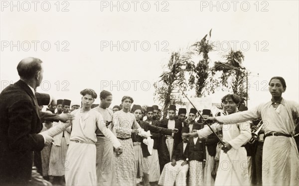 Dancing at an Arab wedding, Palestine. Several men perform a traditional dance at an Arab wedding. British Mandate of Palestine (Middle East), circa 1938., Middle East, Asia.