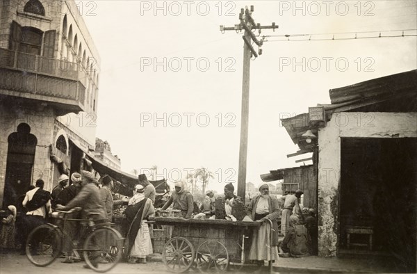 Marketplace in Jaffa. Street traders sell goods from a wheeled cart at a busy marketplace in Jaffa. Jaffa, British Mandate of Palestine (Israel), circa 1938. Jaffa, Tel Aviv, Israel, Middle East, Asia.