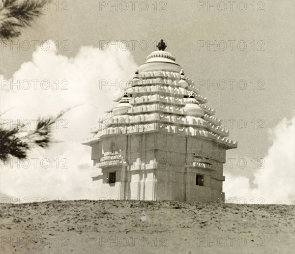 Hindu temple on a beach in Puri. A small Hindu temple is located on a sandy beach in Puri. An original caption identifies it as being used for worship by fishermen. Puri, India, October 1934. Puri, Orissa, India, Southern Asia, Asia.