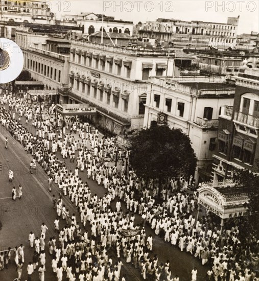 Protest on Old Court House Street, Calcutta, 1946. A crowd of Indian protesters brandish banners as they march along Old Court House Street. The photographer refers to the event as a "Communist demo", but it could be any one of a number of uprisings that plagued Calcutta in 1946. Two occasions that seem to fit are an attempt by student demonstrators to enter Dalhousie Square on 11 February, or the August riots relating to Direct Action Day. Calcutta (Kolkata), India, 1946. Kolkata, West Bengal, India, Southern Asia, Asia.