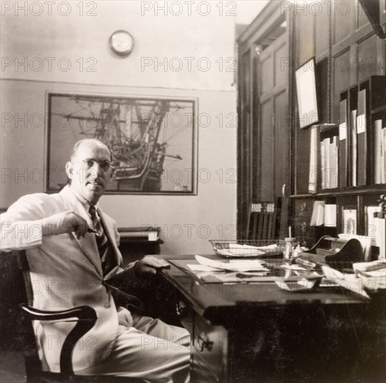 James Murray working in his office, Calcutta. James Murray sits at his desk in the James Murray & Co. offices at Old Court House Street. James Murray & Co. was a British-owned family business that specialised in making chronometers and also operated as a jewellers and opticians. Calcutta (Kolkata), India, 1949. Kolkata, West Bengal, India, Southern Asia, Asia.