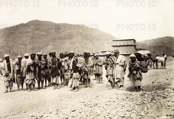 Pashtun men on the Kohat-Peshawar road. A group of Pashtun men gathered on the Kohat to Peshawar road. North West Frontier Province, India (Pakistan), February 1903., North West Frontier Province, Pakistan, Southern Asia, Asia.