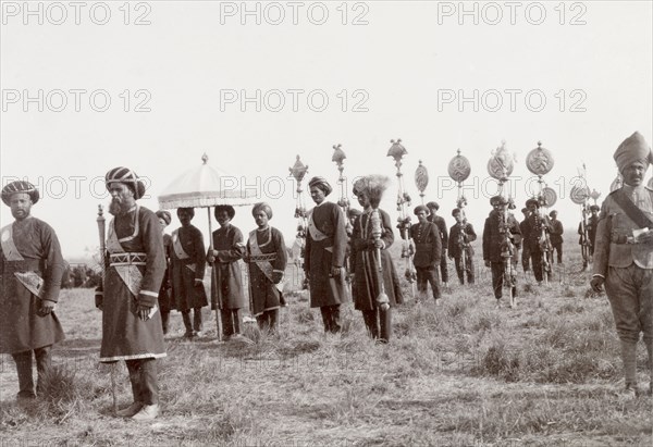 Standard-bearers at Coronation Durbar, 1903. Standard-bearers for an Indian princely state display a selection of ceremonial umbrellas, banners and staffs at the Coronation Durbar. Delhi, India, circa 1 January 1903. Delhi, Delhi, India, Southern Asia, Asia.