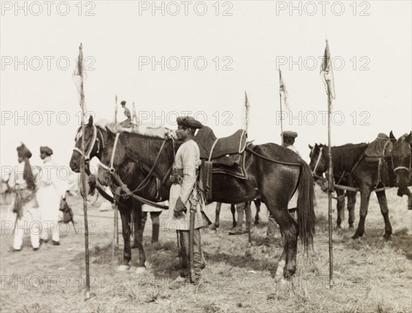 Lancers at Coronation Durbar, 1903. An Indian mounted infantry unit stand with their horses, lances stabbed into the ground beside them, at Edward VII's Coronation Durbar. Delhi, India, circa 1 January 1903. Delhi, Delhi, India, Southern Asia, Asia.