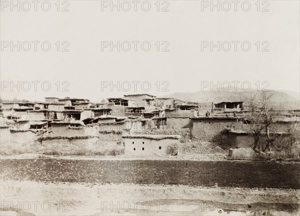 Mud village in North West Frontier Province. View of a village along the Kohat-Thal railway line, where the buildings consist of mud or adobe walls with flat, thatched roofs. North West Frontier Province, India (Pakistan), 1903., North West Frontier Province, Pakistan, Southern Asia, Asia.