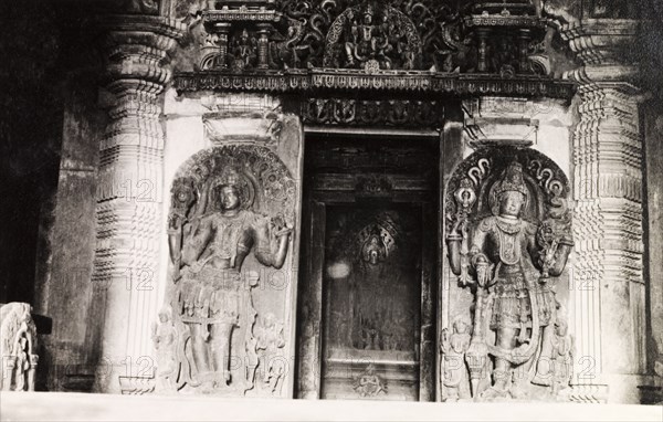 Sculptures at Chennakesava Temple. Two ornately sculpted 'doorkeepers' flank an image of Kesava (Lord Krishna) at Chennakesava Temple, a 12th century Vaishnava temple built by King Vishnuvardhana of the Hoysala dynasty. Belur, Mysore State (Karnataka), India, circa 1937., Karnataka, India, Southern Asia, Asia.