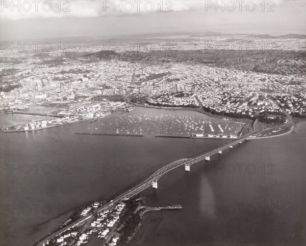 Aerial view of Auckland Harbour Bridge. Auckland Harbour Bridge stretches across Waitemata Harbour towards Auckland city. Auckland, New Zealand, 1966. Auckland, Auckland, New Zealand, New Zealand, Oceania.