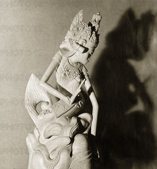 A Hindu figurine from Bali. A intricately carved figurine of a Hindu deity or 'devi' (goddess). Bali, Indonesia, July 1940., Lesser Sunda Islands (including Bali), Indonesia, South East Asia, Asia.