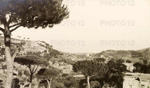 Hillside view from Brumana. Pine trees dot the hills around the mountain village of Brumana. An original caption indicates a view over Beirut in the distance. Brumana, French Mandate of Lebanon (Lebanon), 1941. Brumana, Mount Lebanon, Lebanon, Middle East, Asia.