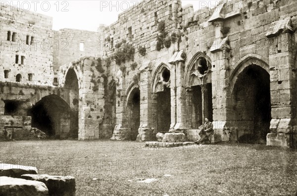 Courtyard inside the Krak de Chevaliers. A ruined courtyard inside the Krak de Chevaliers, a prominent hill fortress in the Homs Gap. Once the headquarters of the Knights Hospitaller during the Crusades (1095-1291), it controlled the road to the Mediterranean and is one of many fortresses that formed a defensive network along the border of the old Crusader states. Homs (Hims), French Mandate of Syria, 1944. Hims, Syria, Syria, Middle East, Asia.