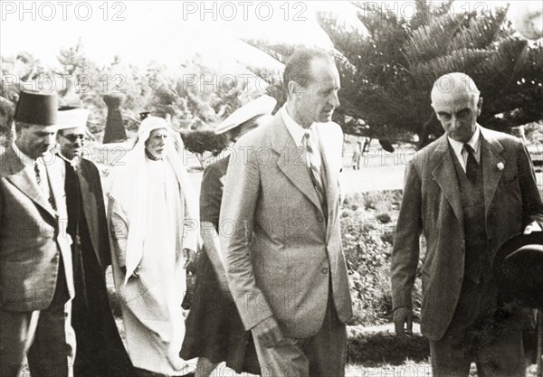 Sir Harold MacMichael and William McGeagh. Sir Harold MacMichael (far right), High Commissioner of the British Mandate of Palestine, talks to William Ryder McGeagh, District Commissioner in Jerusalem, at his farewell party. MacMichael had survived an assassination attempt only four days prior to this photograph, and subsequently left Palestine on 31 August. Probably Jerusalem, British Mandate of Palestine (Israel), 12 August 1944. Jerusalem, Jerusalem, Israel, Middle East, Asia.