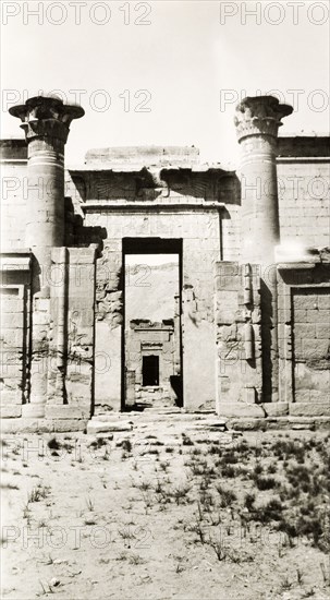 Mortuary Temple of Ramesses III. Two stone pillars stand either side of a gateway decorated with hieroglyphs at the Mortuary Temple of Ramesses III. Medinet Habu near Luxor, Egypt, February 1945. Luxor, Qina, Egypt, Northern Africa, Africa.