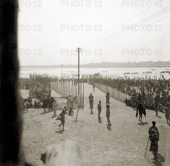 Procession route to the Triveni Sangam. Staked fences mark the procession route down to the Triveni Sangam (the holy confluence of the Yamuna, Saraswati and Ganges Rivers) at the Ardh Kumbh Mela. Allahabad, United Provinces (Uttar Pradesh), India, January 1936. Allahabad, Uttar Pradesh, India, Southern Asia, Asia.