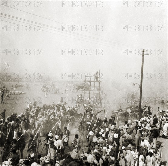 Procession at the Ardh Kumbh Mela. A procession passes through crowds of Hindu pilgrims on its way to the Triveni Sangam (the holy confluence of the Yamuna, Saraswati and Ganges Rivers) at the Ardh Kumbh Mela. Allahabad, United Provinces (Uttar Pradesh), India, January 1936. Allahabad, Uttar Pradesh, India, Southern Asia, Asia.