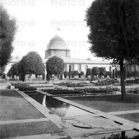 View of the Viceroy's House in New Delhi. View across Mughal-style gardens, looking towards the Viceroy's House (Rashtrapati Bhavan), where a union jack flies from the top of its dome. New Delhi, India, December 1939. Delhi, Delhi, India, Southern Asia, Asia.