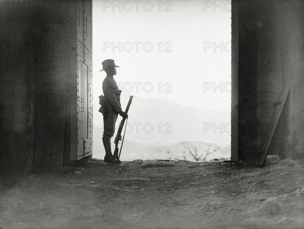 Guarding the entrance to 'Fort Malakand'. An armed officer of the Eighth Royal Gurkha Rifles stands to attention as he guards the entrance to 'Fort Malakand'. North West Frontier Province, India (Pakistan), circa 1920., North West Frontier Province, Pakistan, Southern Asia, Asia.