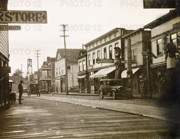 A boardwalk street in Wrangell. Shops flank a boardwalk street in the centre of Wrangell. Wrangell, Alaska, United States of America, circa 1931. Wrangell, Alaska, United States of America, North America, North America .