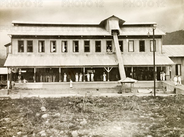 Sailors visit a coffee plantation. British Royal Navy sailors from HMS Dauntless explore a processing factory during a visit to a coffee plantation. Probably Costa Rica, circa 1931. Costa Rica, Central America, North America .