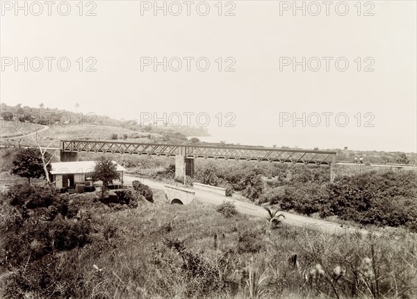 Railway bridge at Pointe-a-Pierre, Trinidad. A bridge carries a Trinidad Government Railways extension line across an incline at Pointe-a-Pierre. Pointe-a-Pierre, Trinidad, circa 1912. Point-a-Pierre, Trinidad and Tobago, Trinidad and Tobago, Caribbean, North America .