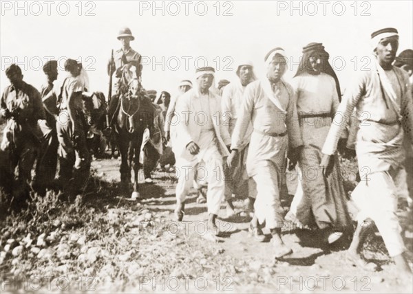 Marching Palestinian Arabs to a detention centre. British soldiers march a group of Palestinian Arabs to a detention centre for questioning. During the period of the Great Uprising (1936-39), an additional 20,000 British troops were deployed to Palestine in an attempt to clamp down on Arab dissidence. British Mandate of Palestine (Middle East), 1938., Middle East, Asia.