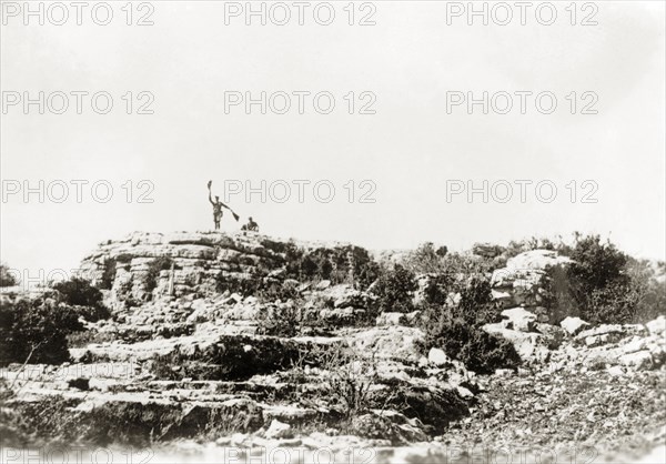 Semaphore signalling, Palestine. A British officer of the Royal Corps of Signals uses semaphore flags to communicate from a rocky outcrop in the Palestinian countryside. During the period of the Great Uprising (1936-39), an additional 20,000 British troops were deployed to Palestine in an attempt to clamp down on Arab dissidence. British Mandate of Palestine (Middle East), circa 1938., Middle East, Asia.