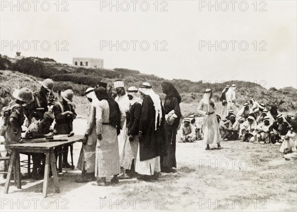 British military questioning Palestinian Arabs. British military officers question a group of Arab villagers. During the period of the Great Uprising (1936-39), an additional 20,000 British troops were deployed to Palestine in an attempt to clamp down on Arab dissidence. British Mandate of Palestine (Middle East), circa 1938., Middle East, Asia.