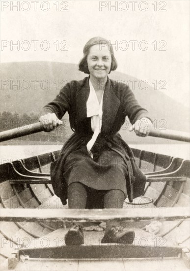 Beryl Phelps rows a boat. Portrait of Beryl Phelps rowing a boat off the shore at Eastbourne. Eastbourne, England, circa 1922. Eastbourne, Sussex, England (United Kingdom), Western Europe, Europe .