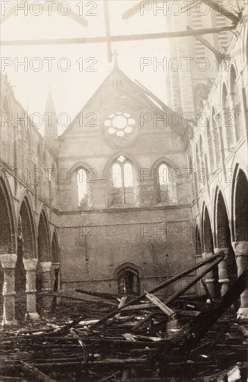 Interior of a fire damaged church. The interior of All Saints Church in Eastbourne in the aftermath of a devastating fire. The stone church stands roofless, its charred roof timbers lying in a tangled mess on the church floor. Eastbourne, England, 1926. Eastbourne, Sussex, England (United Kingdom), Western Europe, Europe .