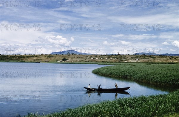 Fishermen in the Kazinga Channel'. Three men in a canoe fish with nets in The Kazinga Channel, half a mile wide flows from Lake George to Lake Edward in the Queen Elizabeth National Park. West Uganda, 1956., West (Uganda), Uganda, Eastern Africa, Africa.