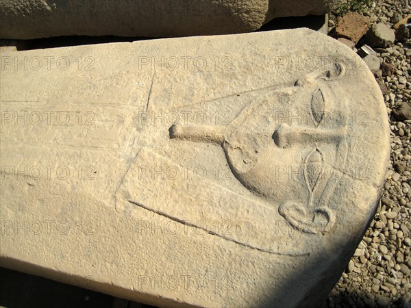 Row of empty carved stone sarcophagi in the courtyard of the Temple of Hathor