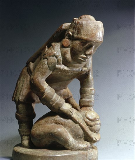 Soapstone pipe, generally assumed to depict a warrior beheading his victim