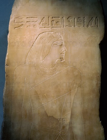 An alabaster panel decorated in sunk relief with a profile head and torso of Rawer