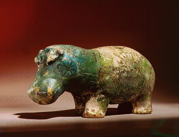 Statuette of hippopotamus from a burial, with depictions of marsh plants on his body