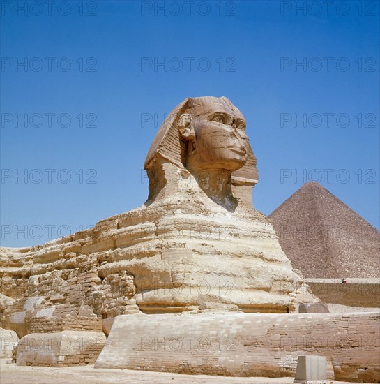 The Giza Sphinx with the pyramid of Khufu in the background