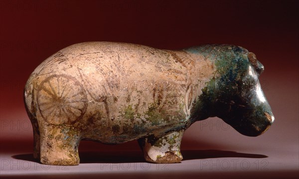 Statuette of hippopotamus from a burial, with depictions of marsh plants on his body